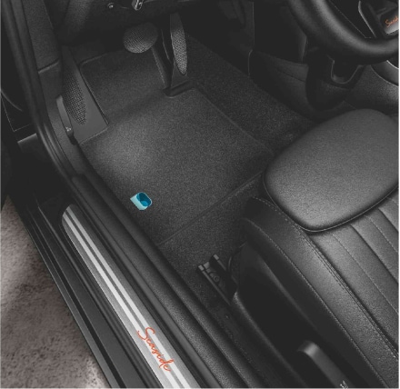 Closeup view of the interior of a MINI Cooper S Convertible Seaside Edition, particularly the door sills with the SEASIDE 30 insignia in brushed alloy and the floor mat piercing.