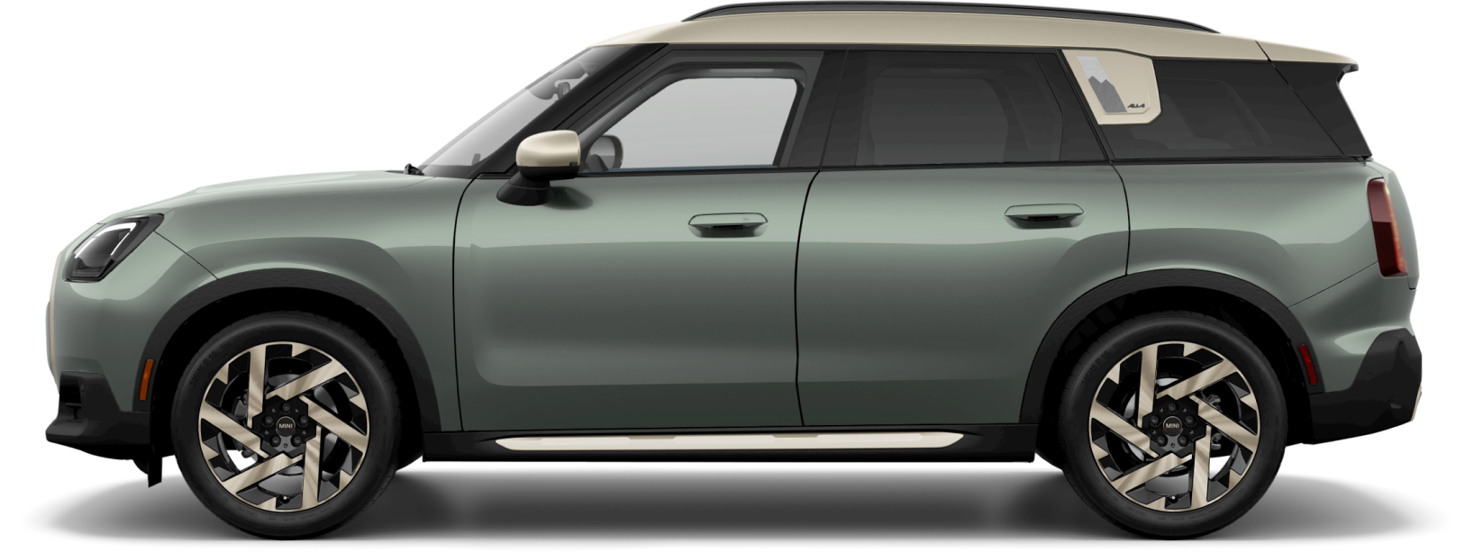 Side view of a 2025 MINI Countryman S ALL4 in the Smokey Green body color, facing left with its shadow underneath it